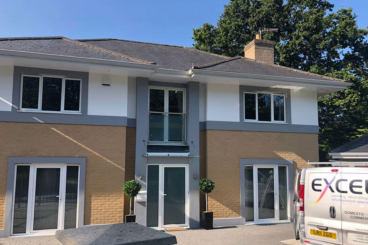 Excel Decorating van outside of a building